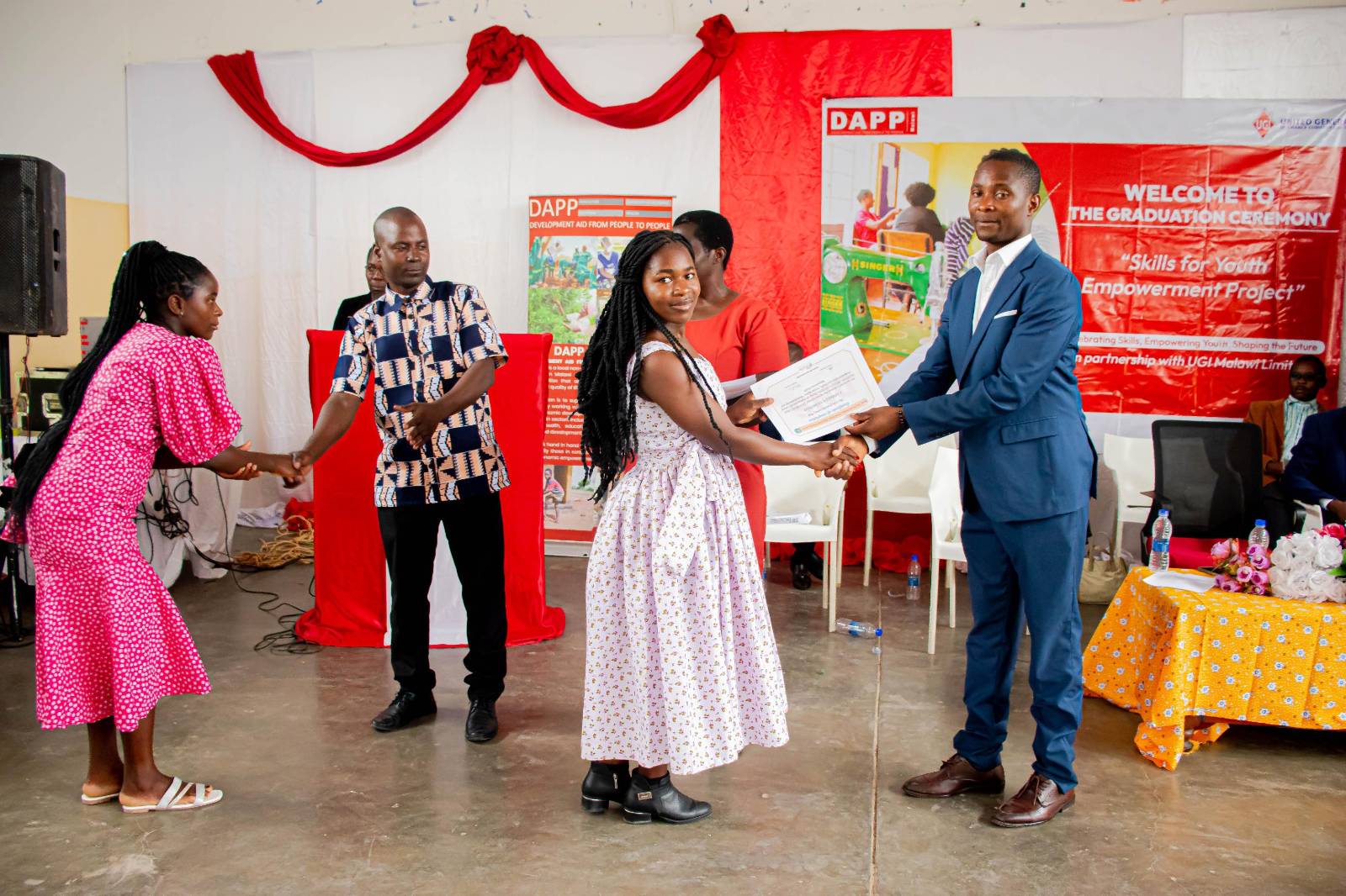 Catherine Nyirongo receiving her certificate during graduation ceremony