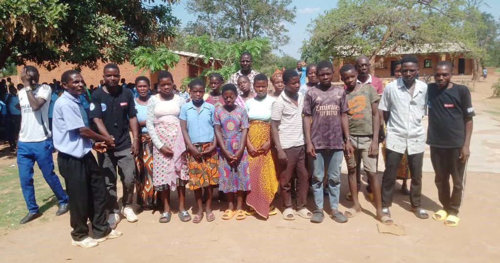 Community Action Coordinator of Banga welcoming Girls and Boys back to school